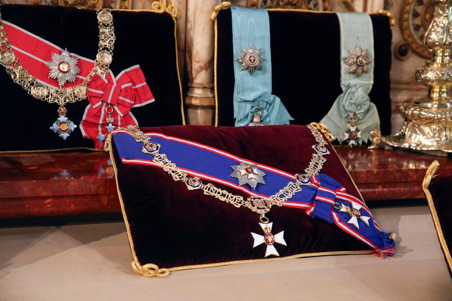 Insignia belonging to Britain's Prince Philip, Duke of Edinburgh, the Royal Victorian Order Collar and Badge, and the Royal Victorian Order Breast Star and Badge (front) and The Order of the Elephant (Denmark), and the Order of the Redeemer (Greece), are seen arranged on the altar in St George's Chapel in Windsor Castle, Windsor, west of London, on April 16, 2021 on the eve of the duke's funeral.  Queen Elizabeth II bids a final farewell to her late husband Prince Philip, at a funeral restricted by coronavirus rules but reflecting his long life of military and public service. Prince Philip died on April 9 at the age of 99. / AFP / POOL / Steve Parsons
