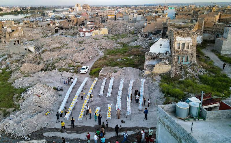Iraqis set tables before a collective iftar on the second day of Ramadan in the war-ravaged old part of the northern city of Mosul. AFP