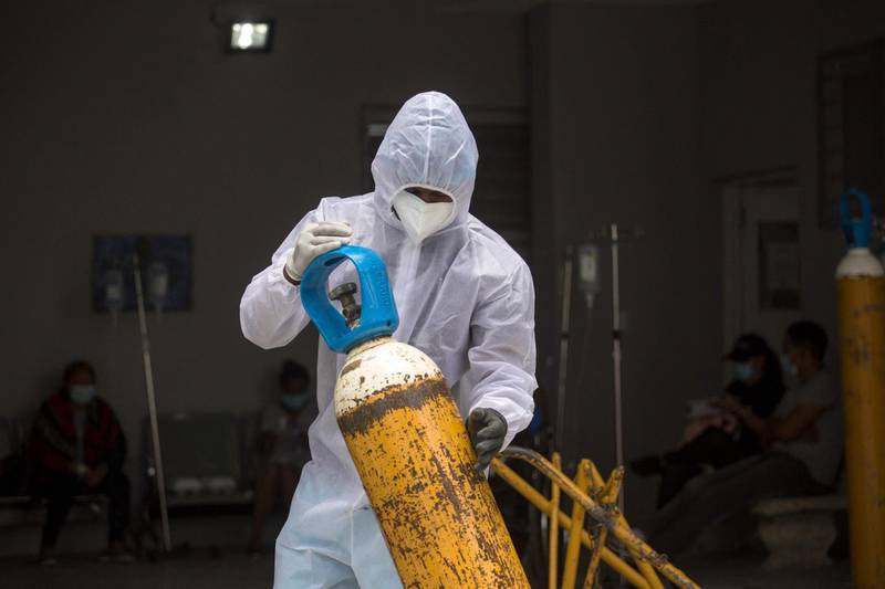 A health worker moves oxygen tanks at the Covid unit of the Moscoso Puello hospital in Santo Domingo, Dominican Republic. AFP