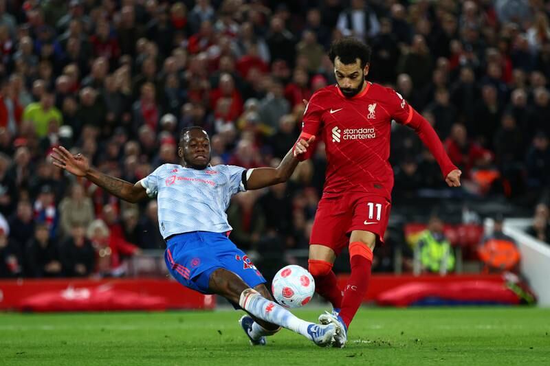 Salah scores the fourth goal whilst under pressure from Aaron Wan-Bissaka. Getty