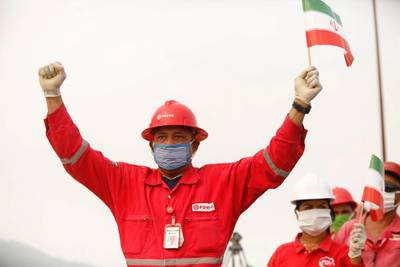 A worker of the state-oil company Pdvsa holds an Iranian flag during the arrival of the Iranian tanker ship "Fortune" at El Palito refinery in Puerto Cabello, Venezuela.  Reuters