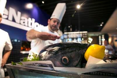 ABU DHABI, UNITED ARAB EMIRATES, Mar. 28, 2015:  
(C) Justin Galea, Executive Chef and Director Food & Beverage at the Le Royal Meridien hotel in Abu Dhabi, looks over a tuna fish as he introduces the day's plan and ingredients at a #healthyliving cooking experience, organized by The National, on Saturday, Mar. 28, 2015, at the hotel in downtown Abu Dhabi. (Silvia Razgova / The National)  (Usage: undated, #healthyliving Section: Healthy living mag, Reporter: Stacie Johnson) *** Local Caption ***  SR-150328-cooking22.jpg
