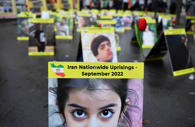 Placards with portraits of the victims of Iran's repression displayed near the French National Assembly in Paris. AFP