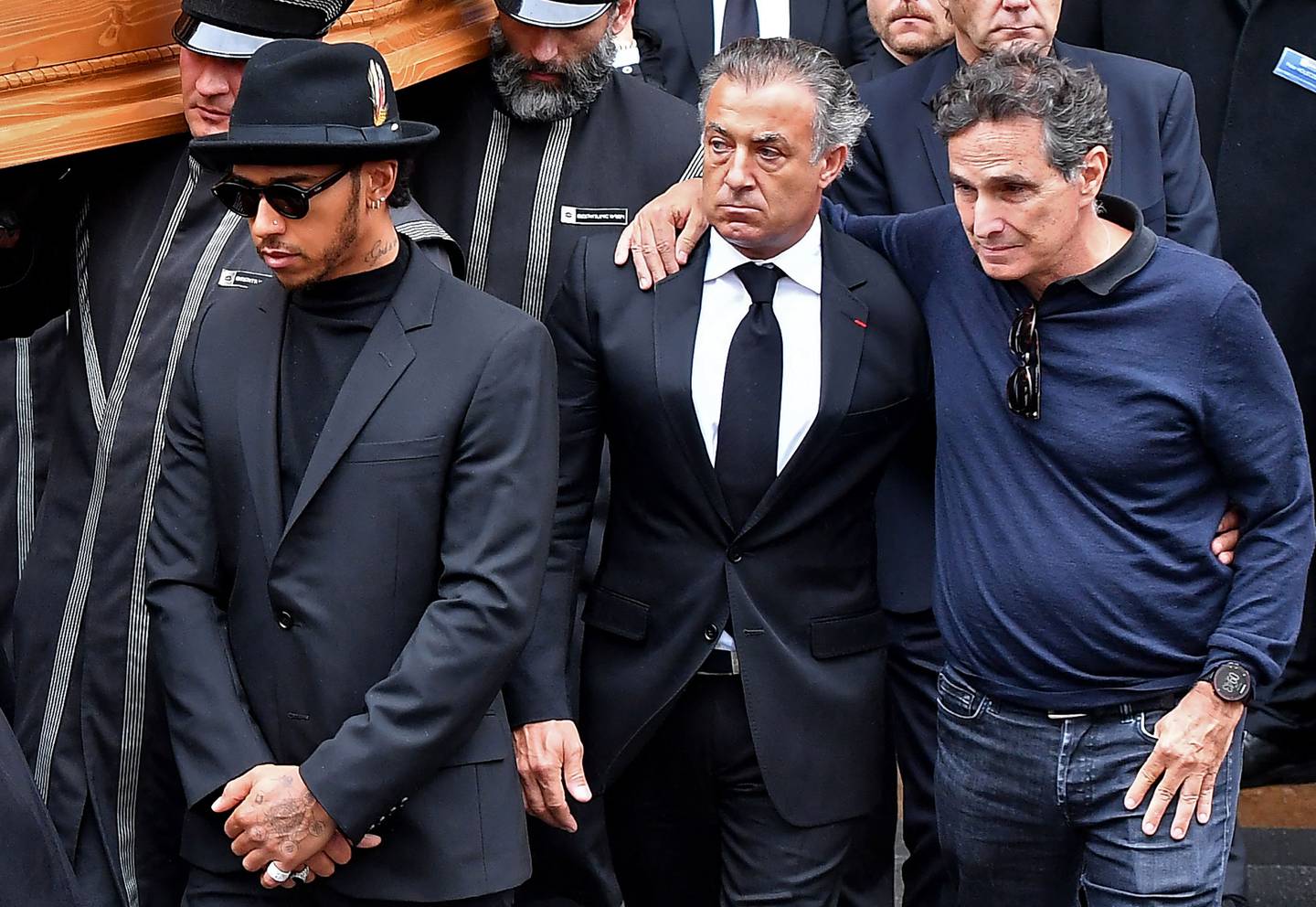 (FILES) In this file photo taken on May 29, 2019, former Formula One drivers Nelson Piquet, right, and Jean Alesi, centre, and British Formula One champion Lewis Hamilton, left, escort the coffin of late Austrian three-time Formula One world champion Niki Lauda. AFP