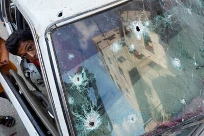 A Palestinian boy looks out of a car damaged amid Israel-Gaza fighting, in the northern Gaza Strip. Reuters