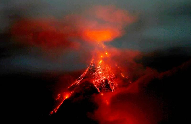 Molten rocks and lava flow down the slopes of Mayon volcano during its mild eruption as seen from Legazpi city, Albay province, southeast of Manila, Philippines. Bullit Marquez / AP Photo