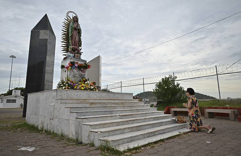 A woman prays before an image of the Virgin of Guadalupe, before Pamela makes landfall at Mazatlan. AP Photo