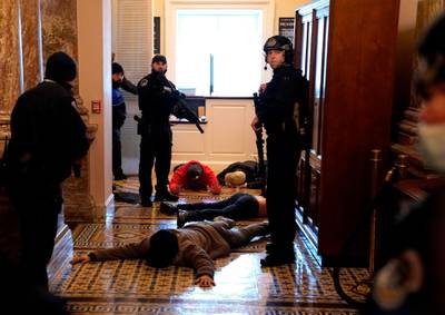 US Capitol Police stand detain protesters outside of the House Chamber during a joint session of Congress. AFP