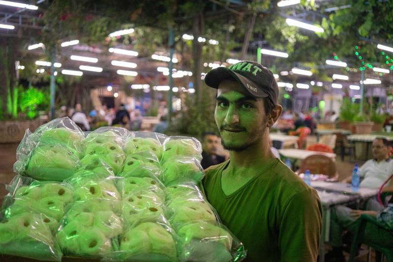 A vendor selling sweets at Tal Olya Cafe in Tripoli during Ramadan