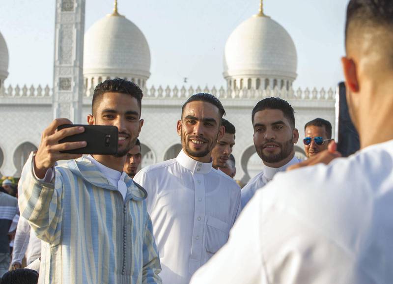 Abu Dhabi, UNITED ARAB EMIRATES -Group photo opportunity after performing morning prayers on the first day of Eid-Al Fitr at the Sheikh Zayed Grand Mosque.  Leslie Pableo for The National