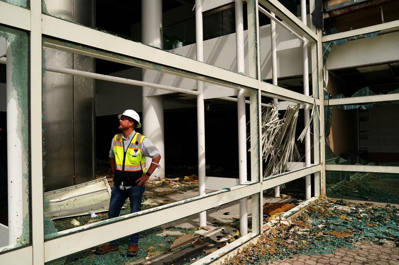 A man checks a damaged building after Hurricane Laura passed through Lake Charles, Louisiana. Reuters