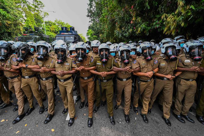 Policemen during a demonstration by Sri Lankan university students against the economic crisis near the parliament building in Colombo. AFP