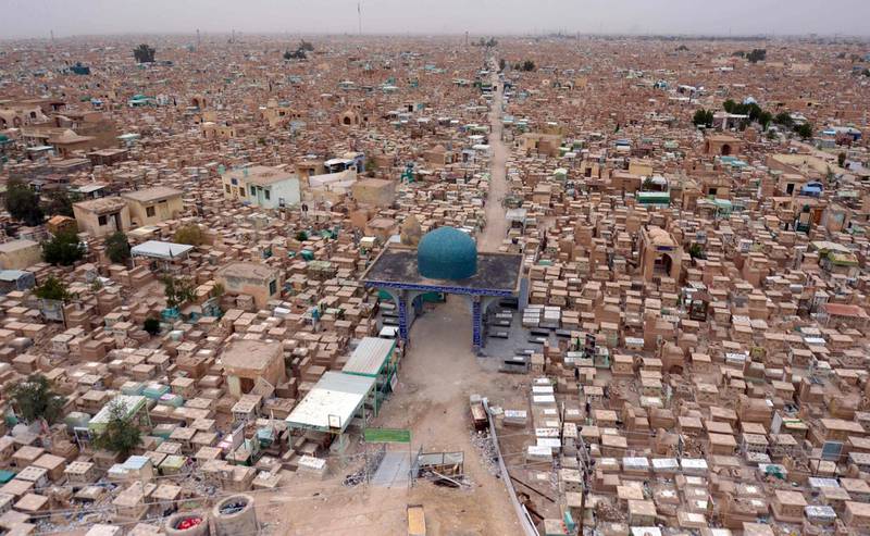 A photograph taken on February 19, 2020, shows a view of the Wadi al-Salam ("Valley of Peace") cemetery in the Iraqi Shiite holy city of Najaf, where Iraqi paramilitary commander Abu Mahdi al-Muhandis was buried. Al-Muhandis was killed alongside a top Iranian general in a US drone strike in Baghdad on January 3, and his final resting place in the world's largest cemetery has gained near-holy status, becoming an anti-US magnet and a stop for thousands of Shiite pilgrims who pass through Najaf each day to visit the tomb of Imam Ali, son-in-law of the Prophet Mohammed. / AFP / Haidar HAMDANI

