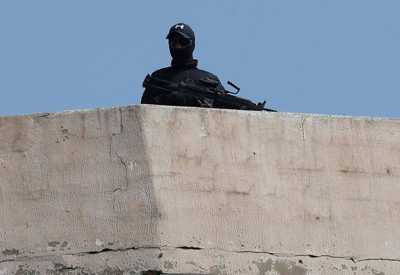 A Lebanese Hezbollah fighter holds his machine gun as he stands guard on a building rooftop during the holy day of Ashoura outside Beirut, Lebanon, Tuesday, Sept. 10, 2019. Millions of Shiite Muslims around the region on Tuesday marked Ashoura, one of the most sacred religious holy days for their sect, holding rallies, prayers and self-flagellation amid soaring tensions in the Middle East. (AP Photo/Hussein Malla)