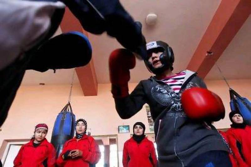 Sadaf Rahimi, right, trains inside a boxing club in Kabul.