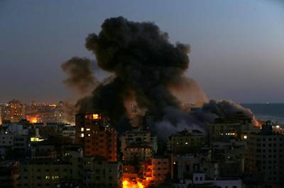 Smoke rises from a burning building, after it was destroyed by Israeli air strikes on Gaza. Reuters