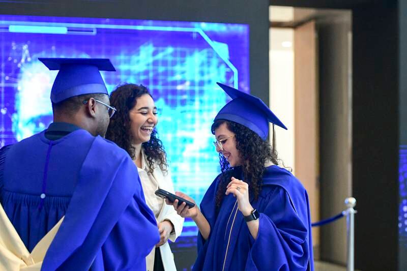 Graduates meet with family and friends after the Mohamed bin Zayed University of Artificial Intelligence (MBZUAI) inaugural commencement ceremony in Abu Dhabi. Khushnum Bhandari / The National 