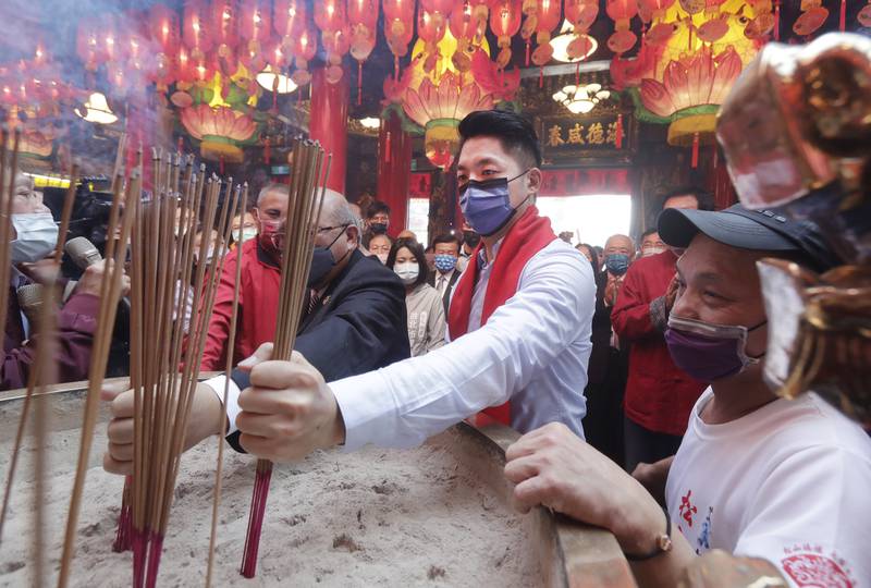 Taipei city mayor Wayne Chiang prays at a temple on the first day of Lunar New Year celebrations. AP
