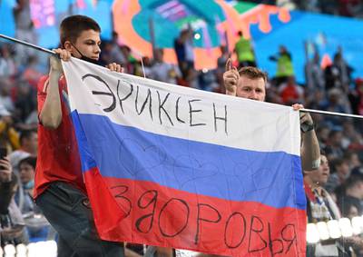 Russian fans hold flag reading "Health to Eriksen" during their match against Belgium later on Saturday. AP