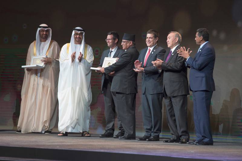 Sheikh Mohammed bin Zayed, Crown Prince of Abu Dhabi and Deputy Supreme Commander of the Armed Forces, and Pushpa Dahal, prime minister of Nepal (centre), present the Zayed Future Energy Prize to Paul Smith Lomas, chief executive of Practical Action, (third from left), in Abu Dhabi. Also in the picture are Danny Faure, president of the Seychelles (right), Nursultan Nazarbayev, president of Kazakhstan (second from right), Horacio Cartes, president of Paraguay (third from right) and Dr Sultan Al Jaber, Minister of State, Chairman of Masdar and Chief Executive of the Adnoc Group. Hamad Al Kaabi / Crown Prince Court — Abu Dhabi