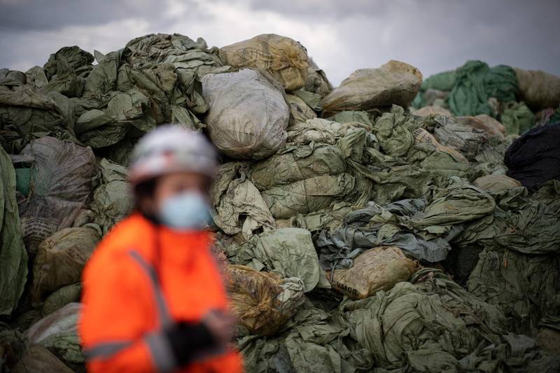 A Suez RV employee walks by piles of agricultural and industrial plastics collected to be recycled at the Suez RV recycling plant in Oree-d'Anjou, western France, on March 26. AFP