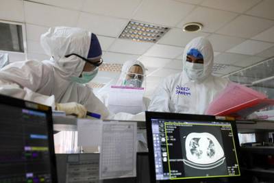 In this Sunday, March 1, 2020 medics wearing protective gear work in a quarantined ward for coronavirus infected patients, at a hospital in Tehran, Iran. Mizan News Agency via AP