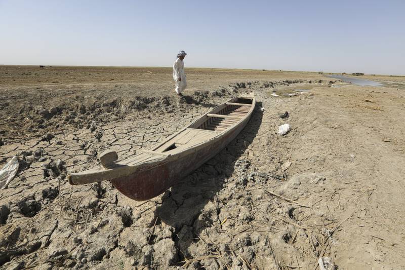 A fisherman with his boat in the drought-stricken Chibaish marshes in Nasiriyah, southern Iraq. All photos: AP