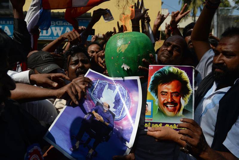 Indian fans of Rajinikanth celebrate after his announcement that he will enter into politics. Arun Sankar / AFP
