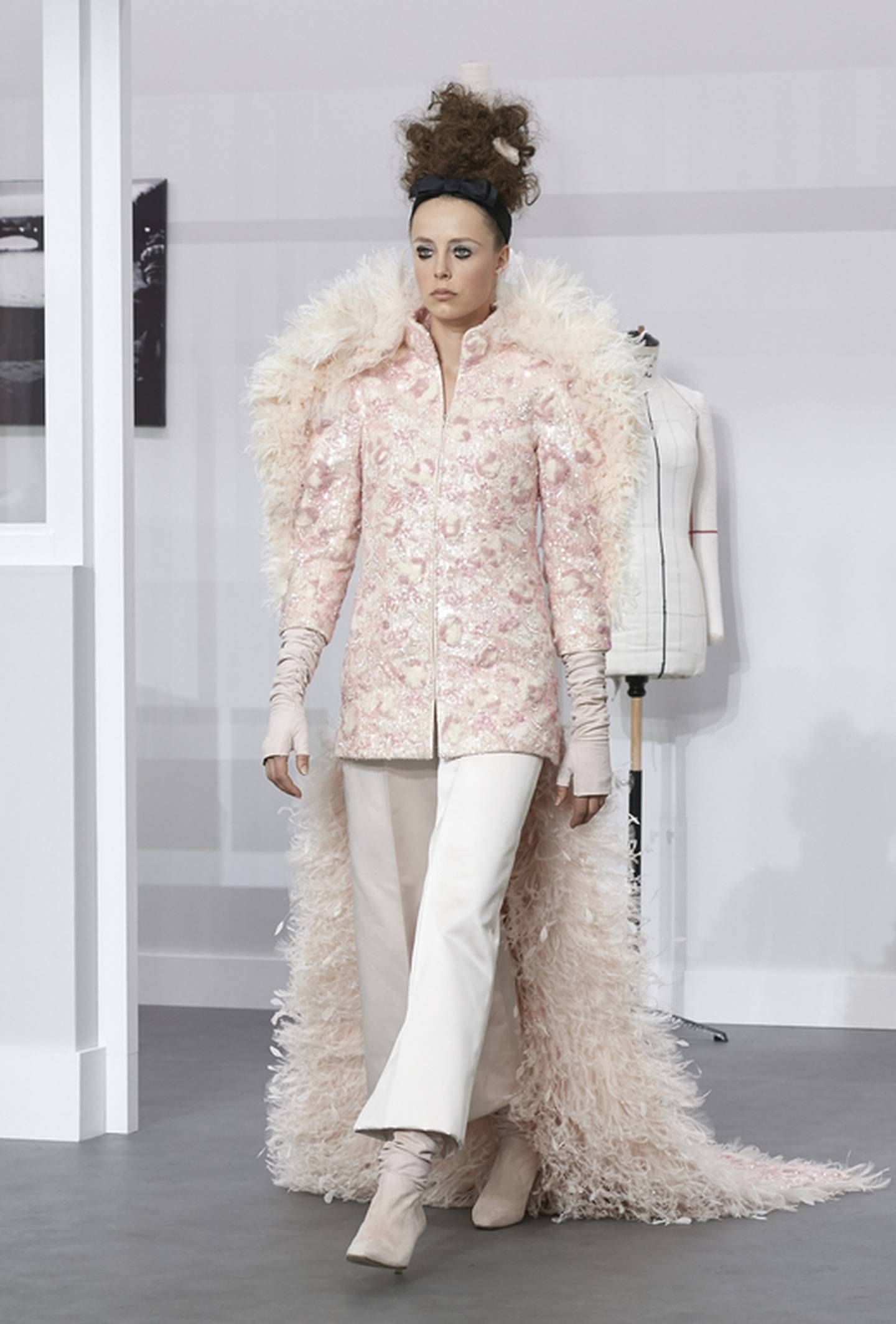 A model in a Karl Lagerfeld bridalwear creation featuring trousers fashioned from lace, tulle and satin, encrusted with strands of pink and white wool. Photo: Chanel
