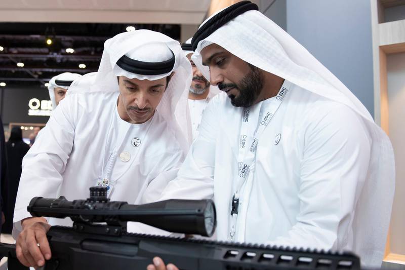 ABU DHABI, UNITED ARAB EMIRATES - February 17, 2019: HH Sheikh Hazza bin Zayed Al Nahyan, Vice Chairman of the Abu Dhabi Executive Council (L), inspects a weapon on the EDIC Caracal stand during a tour of the 2019 International Defence Exhibition and Conference (IDEX), at Abu Dhabi National Exhibition Centre (ADNEC).

( Saeed Al Neyadi / Ministry of Presidential Affairs )
---