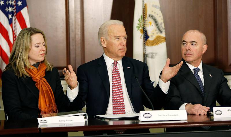 FILE PHOTO: United States Vice President Joe Biden (C) delivers remarks while attending a roundtable on countering violent extremism at the White House in Washington February 17, 2015. Senior Director of the National Security Council Amy Pope (L) and Deputy Secretary of the Department of Homeland Security Alejandro Mayorkas listen.      REUTERS/Gary Cameron/File Photo