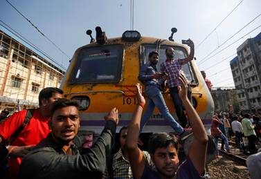 People shout slogans as they block train services during a protest demanding recruitment into the railway services in Mumbai in March. Unemployment rate in India was high even before pandemic wiped out millions of jobs in the country. Reuters