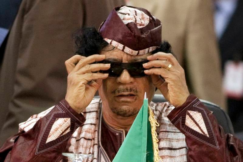 Libya's leader Muammar Gaddafi adjusts his glasses at the Africa-South America Summit on Margarita Island in this September 27, 2009 file photo. Gaddafi died of wounds suffered in his capture near his hometown of Sirte on October 20, 2011, a senior NTC military official said. National Transitional Council official Abdel Majid Mlegta told Reuters earlier that Gaddafi was captured and wounded in both legs at dawn on Thursday as he tried to flee in a convoy which NATO warplanes attacked.  REUTERS/Carlos Garcia Rawlins/Files (VENEZUELA - Tags: POLITICS) *** Local Caption ***  SIN303_LIBYA_1020_11.JPG