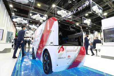 Dubai, United Arab Emirates - December 06, 2020: A visitor walks passed the AI & 5G Autonomous Vehicle from Huawei during GITEX 2020 at the World Trade Centre. December 6th, 2020 in Dubai. Chris Whiteoak / The National