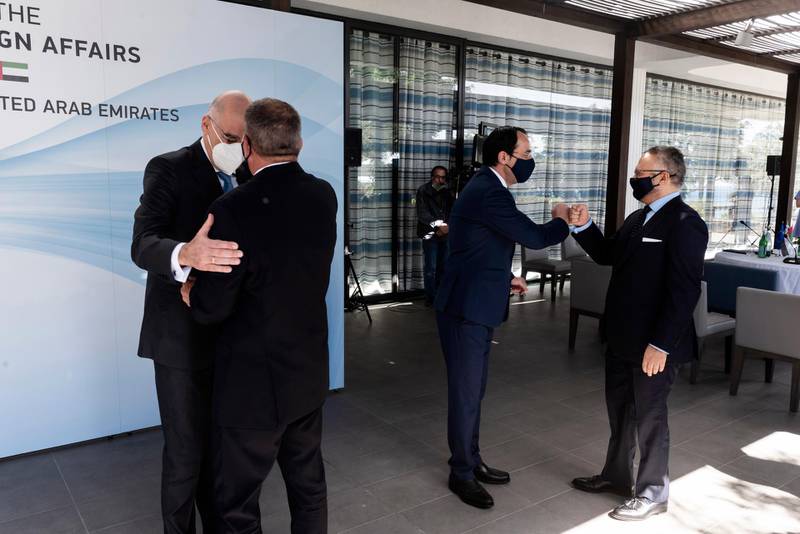 Greek Foreign Minister Nikos Dendias, left, greets Israeli Foreign Minister Gabi Ashkenazi, while Cypriot Foreign Minister Nikos Christodoulides welcomes Anwar Gargash, former UAE state minister for foreign affairs and current diplomatic advisor to the President, Sheikh Khalifa, ahead of a meeting in Paphos, Cyprus. EPA