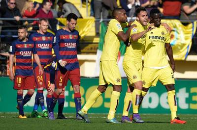 Villarreal players, right, celebrate their second goal during their Primera Liga match against Barcelona at El Madrigal stadium in Vila-real on March 20, 2016. / AFP / JOSE JORDAN