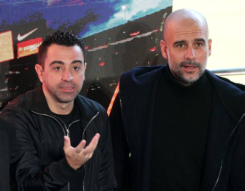 Xavi Hernandez and Pep Guardiola after the press conference. Reuters