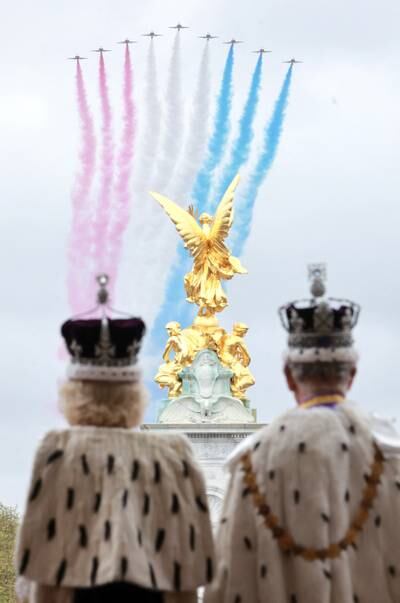 King Charles and Queen Camilla watch the flypast from the balcony of Buckingham Palace. Reuters