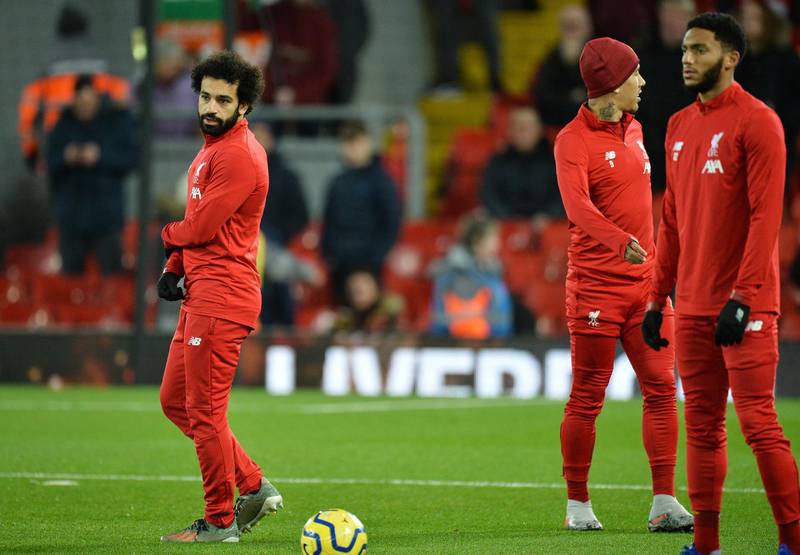 Mohamed Salah (L)  watched from the bench as Liverpool scored five against Everton. EPA