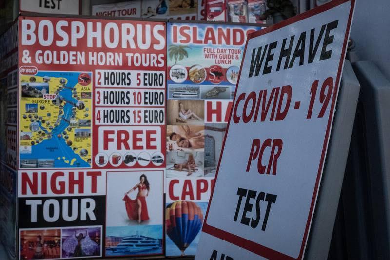 A sign offering tourists Covid-19 PCR tests is seen in front of a tour operator's shop in Istanbul. Getty Images