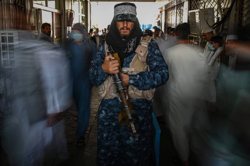 A Taliban fighter stands guard at a market in Kabul on September 5, 2021. AFP