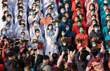 Medical staff celebrate after all patients were discharged at Wuchang Fangcang Hospital, a temporary hospital set up at Hongshan Gymnasium to treat people infected with the coronavirus and COVID-19 disease, in Wuhan, Hubei Province, China, 10 March 2020. EPA