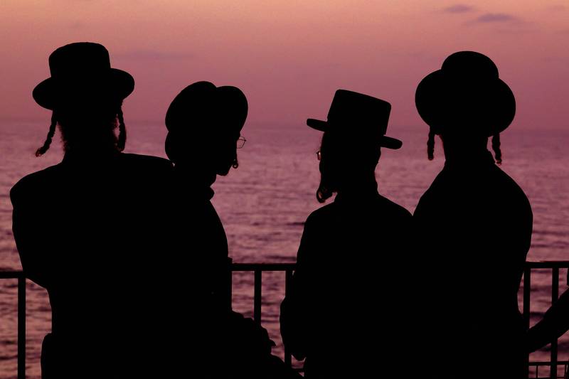 Ultra-Orthodox Jewish men and children perform the Tashlich ritual before the start of Yom Kippur, in Netanya, Israel. Tashlich is the practice by which Jews go to a large body of water, preferably one containing fish, and symbolically cast of their sins by throwing a piece of bread, or similar food, into the water. AFP