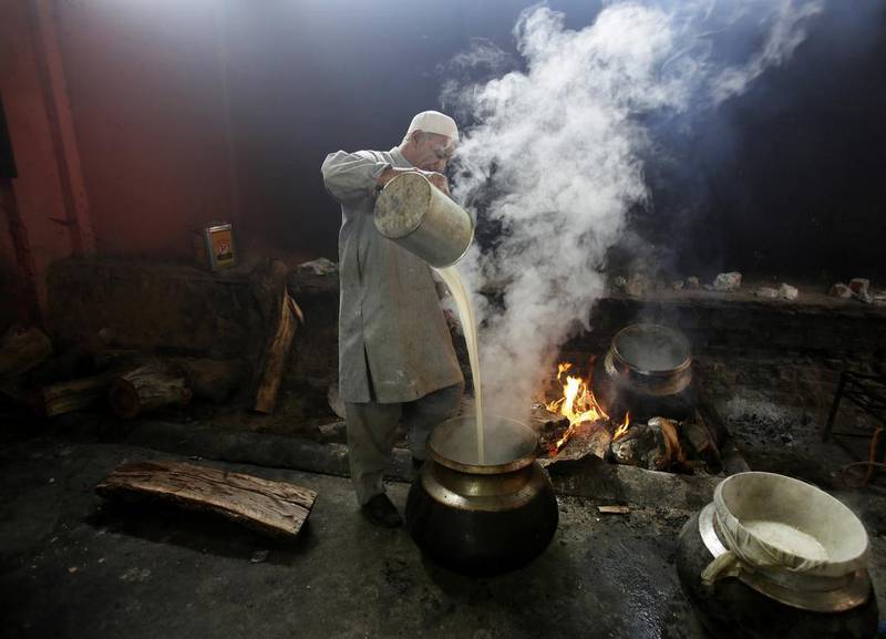 A Kashmiri cook prepares soup to sell from his home, during a strike in Srinagar.  Mukhtar Khan / AP Photo