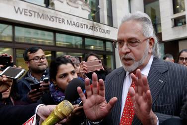 Indian businessman Vijay Mallya is surrounded by reporters as he leaves Westminster Magistrates' Court in London. An Indian court has declared the tycoon a Fugitive Economic Offender, a ruling that empowers the authorities to confiscate his properties and assets. AP