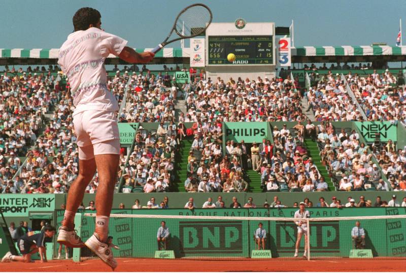 31 MAY 1994:  WORLD NUMBER 0NE PETE SAMPRAS OF THE USA JUMPS OFF THE GROUND TO PLAY A FOREHAND RETURN AS NUMBER SEVEN SEED JIM COURIER OF THE USA WAITS ON THE OTHER SIDE OF THE COURT IN ONE OF THE QUARTERFINALS OF THE FRENCH OPEN TENNIS AT ROLAND GARROS,PARIS.  Mandatory Credit: Gary Prior/ALLSPORT