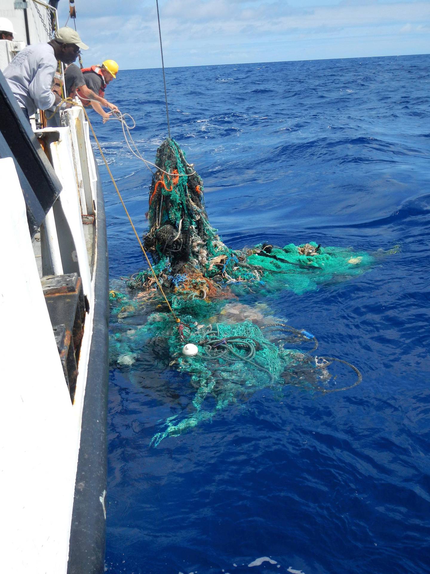 (FILES) This handout photo released on March 22, 2018 by the Ocean Cleanup shows Mega Expedition mothership R/V Ocean Starr crew pulling a ghost net from the Pacific Ocean in 2015. 
Researchers in the US and Britain have accidentally engineered an enzyme which eats plastic and may eventually help solve the growing problem of plastic pollution, a study said on April 17, 2018. More than eight million tons of plastic are dumped into the world's oceans every year, and concern is mounting over this petroleum-derived product's toxic legacy on human health and the environment. / AFP PHOTO / Ocean Cleanup / Handout / RESTRICTED TO EDITORIAL USE - MANDATORY CREDIT "AFP PHOTO / OCEAN CLEANUP" - NO MARKETING NO ADVERTISING CAMPAIGNS - DISTRIBUTED AS A SERVICE TO CLIENTS