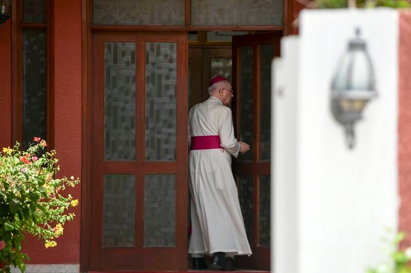 Bishop Paul Hinder entering his residences in Abu Dhabi. 
