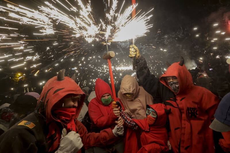 People take part in the traditional 'correfoc' event in Barcelona, Spain. During the event people dress as demons and run through the streets lighting fireworks.  EPA 