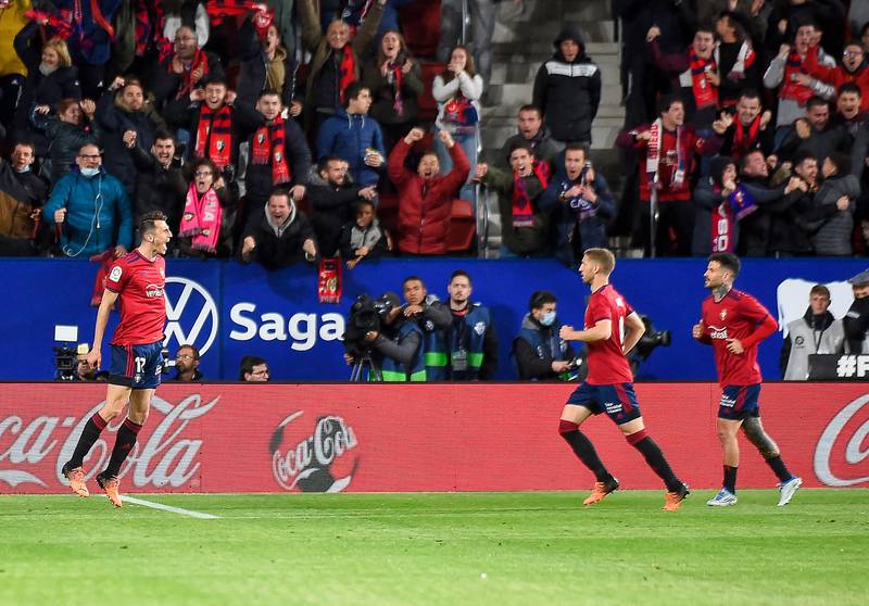 Osasuna forward Ante Budimir celebrates with teammates after scoring the equaliser against Real Madrid. AFP